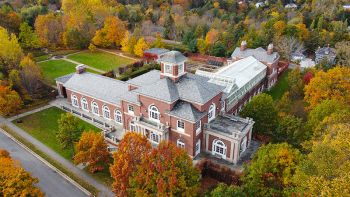 An aerial photo of the KC Irving Centre surrounded by mature autumn foliage.