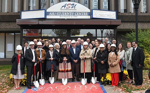 A large group of special guests poses with shovels in front of the Students' Union Building to celebrate groundbreaking for the Eleanor Johnson Student Centre