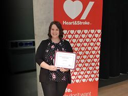 Laura Smith poses with her research award certificate