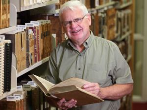 Professor Emeritus Barry Moody in a library