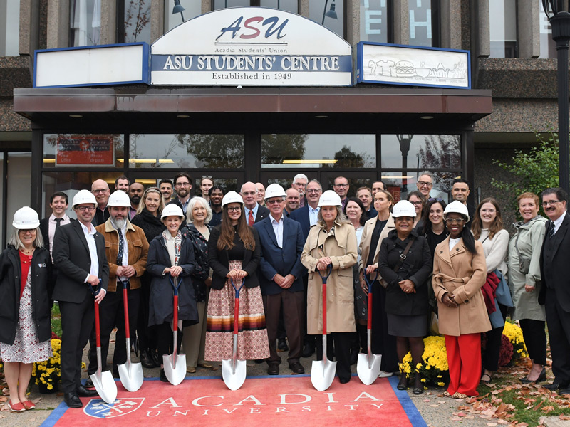 A large group of special guests poses with shovels in front of the Students' Union Building to celebrate groundbreaking for the Eleanor Johnson Student Centre