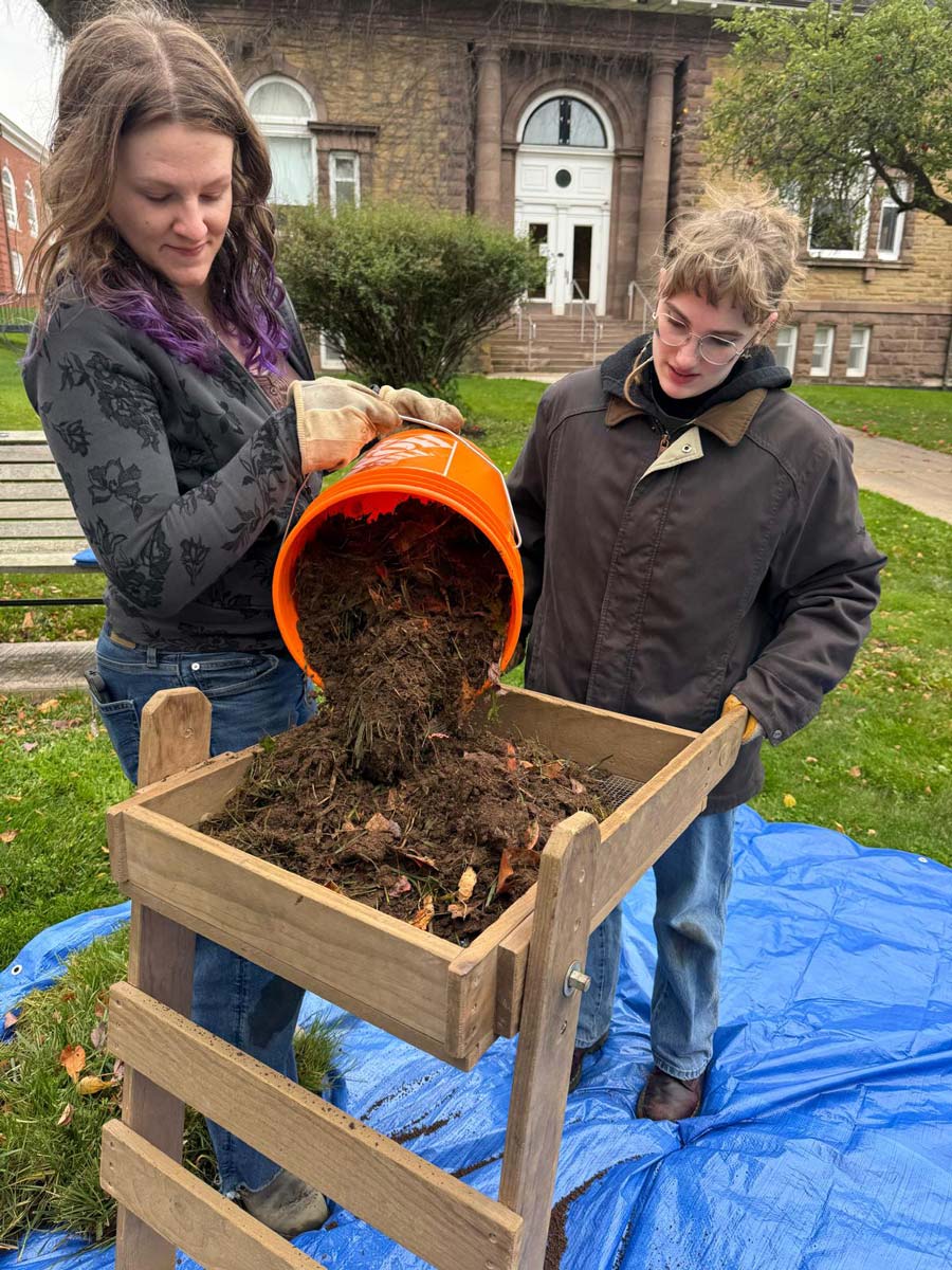 Students sift soil for archaeological fragments on Acadia's South Lawn.