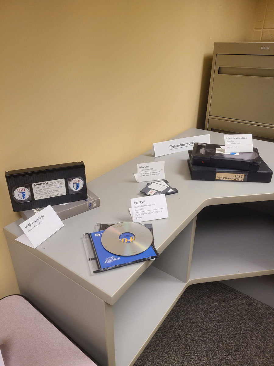 A display of video and data storage mediums like CD-RW's, VHS cassettes, and 3.5" floppy disks