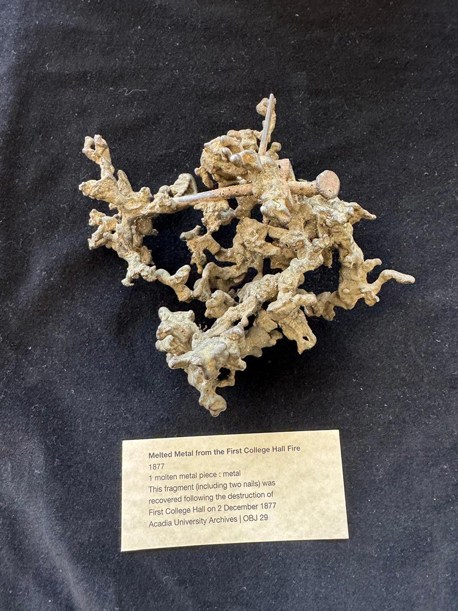 A display of molten metal from the first College Hall fire in 1877, which includes two nails in a strange, jumbled shape.