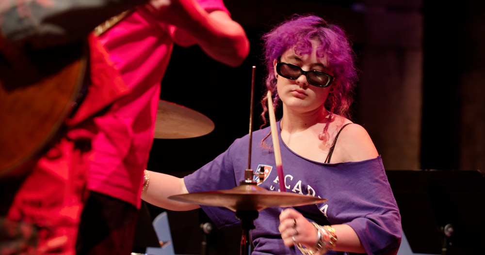 A drummer performing in the Atlantic Theatre Festival venue.