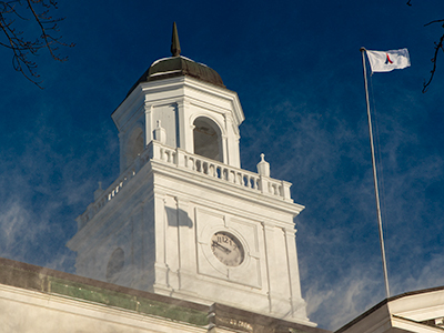 University Hall flying the Campaign for Acadia flag on a frigid december morning.