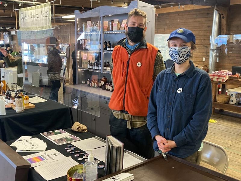 Zackery Pate and Taryn Muldoon with their display at the Wolfville Farmers Market. Image courtesy of Youth Partnership Initiative.