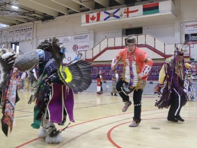 Indigenous dancers perform in traditional regalia on Stu Aberdeen Court